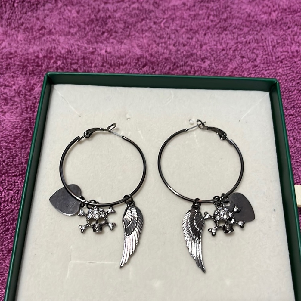 Medium size hoop earrings with a feather skull and heart charms
